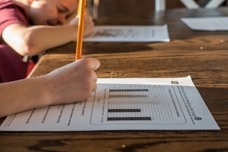 person writing on white paper