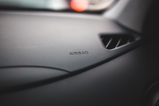 A close-up of an airbag module on a workbench.
