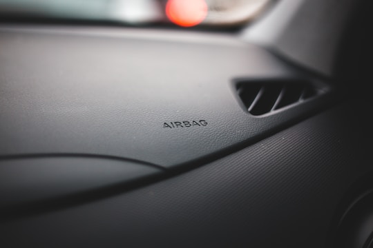A close-up of an airbag module being inspected.