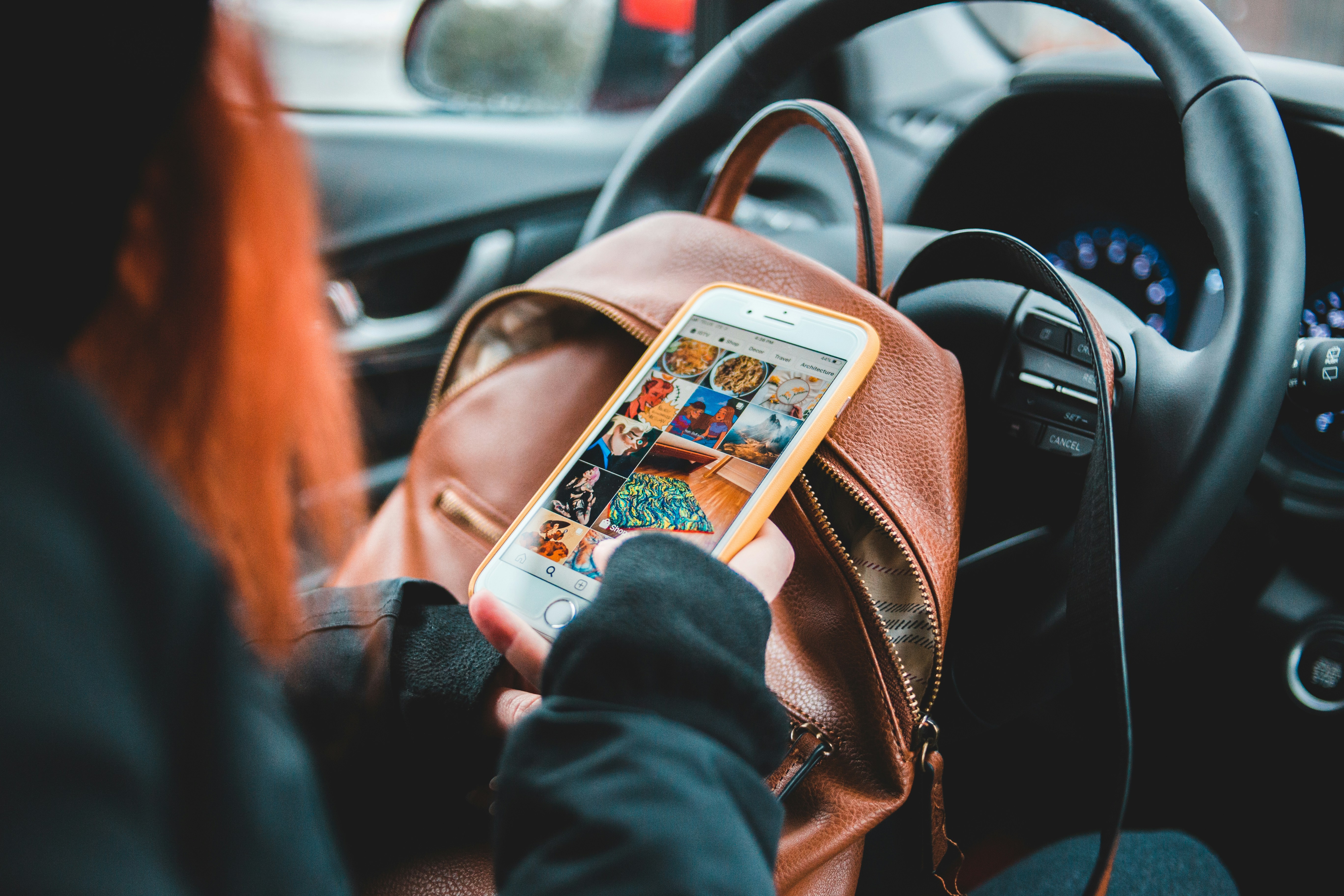 woman holding iphone 6 with orange and black case