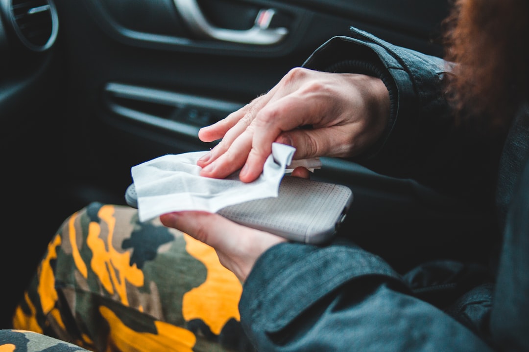 person in black jacket holding white paper