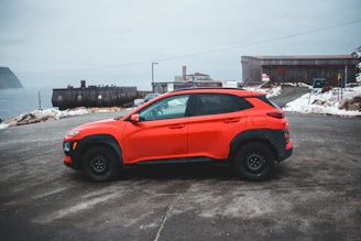 A compact SUV ready for a week-long trip, parked near a popular Orlando landmark.