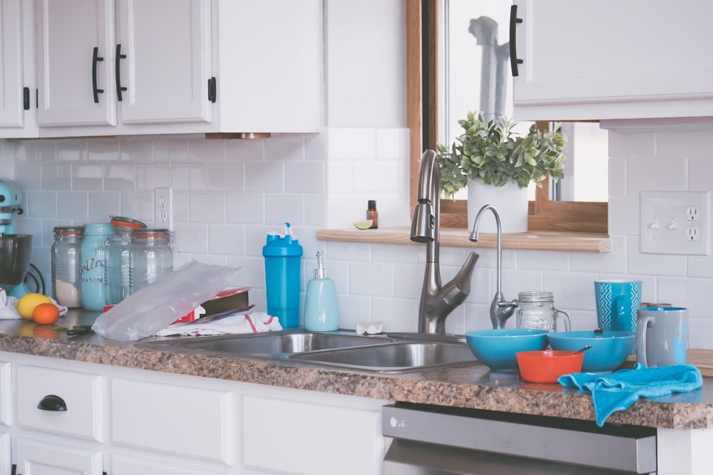 blue plastic pitcher on stainless steel sink