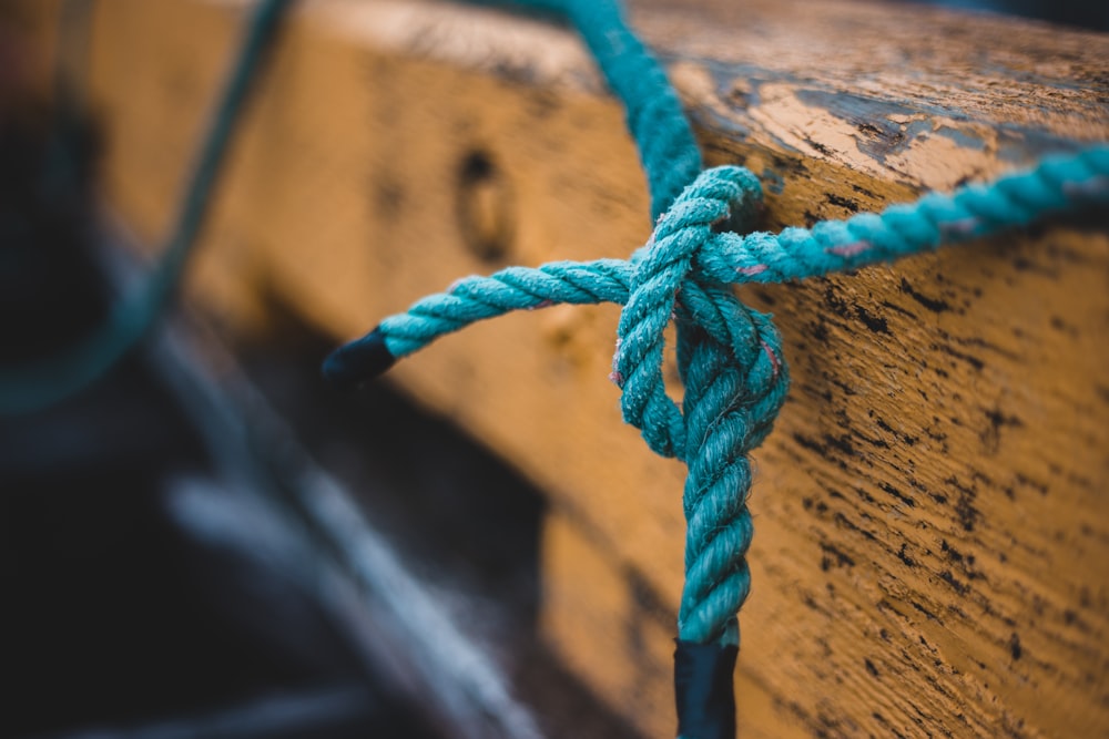 blue rope on brown wooden surface