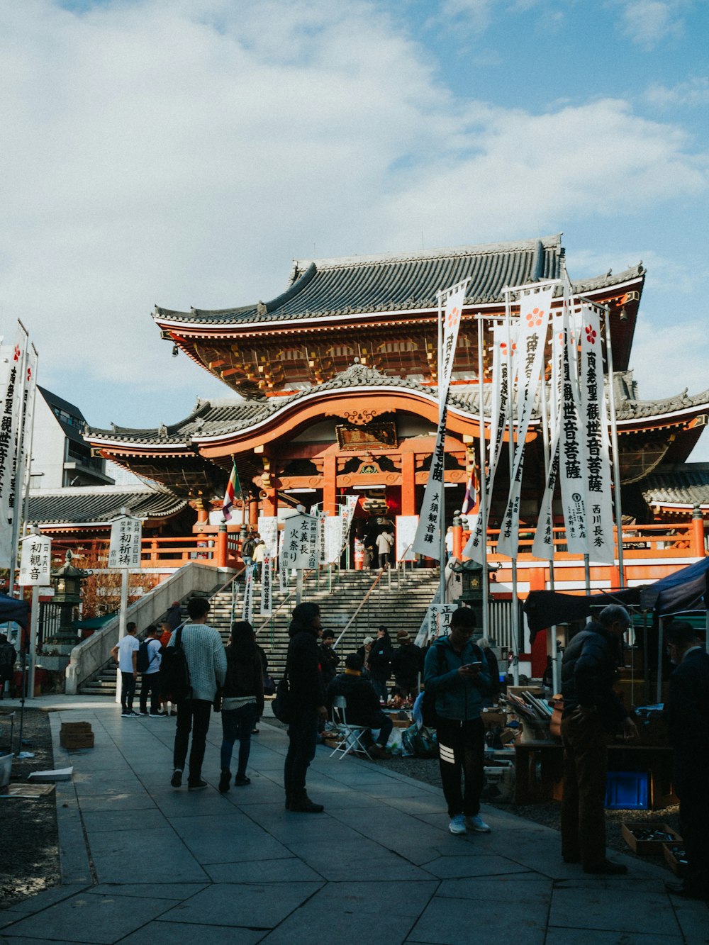 people walking on street near brown and white temple during daytime