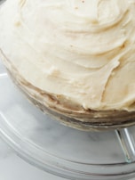 Step-by-step photo showing the buttercream application on a cake.