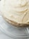 Close-up of a delicious artisanal cake with intricate frosting details on a wooden table.