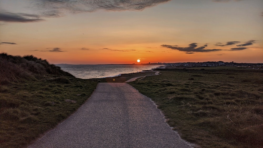 gray sand beach during sunset