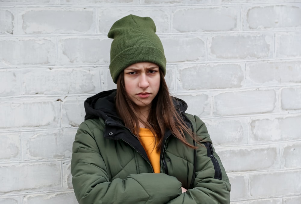 woman in green knit cap and green jacket