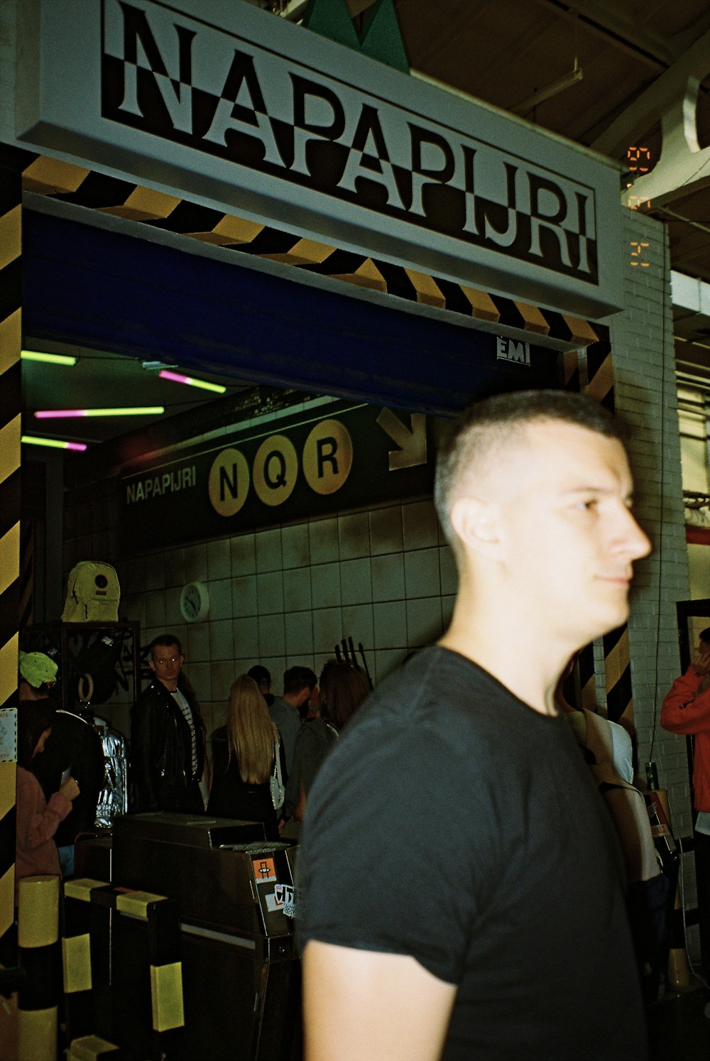 man in black crew neck shirt standing near people
