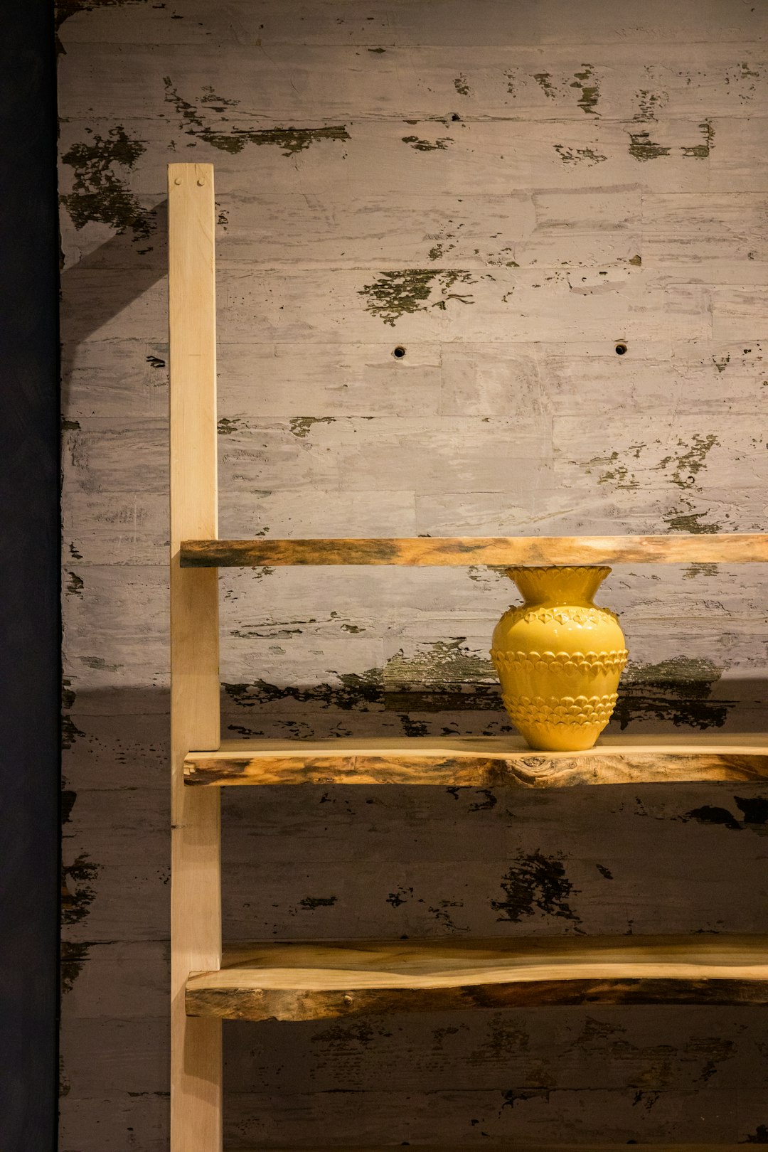 white ceramic vase on brown wooden shelf