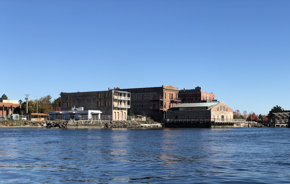 brown concrete building near body of water during daytime