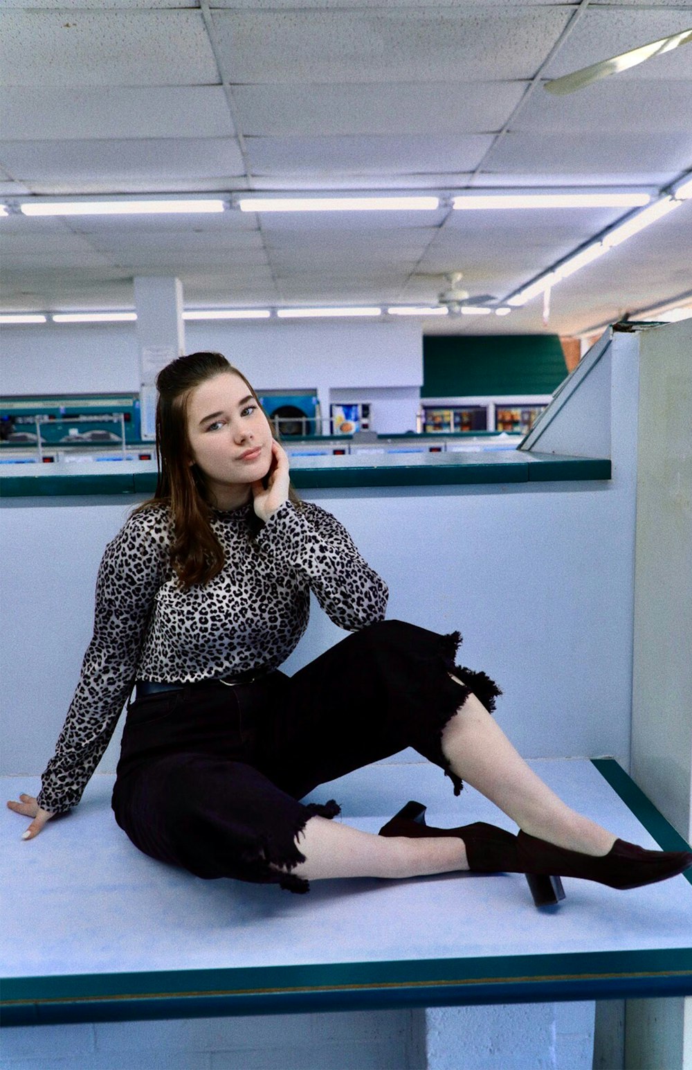 woman in black and white long sleeve shirt and black pants sitting on blue yoga mat