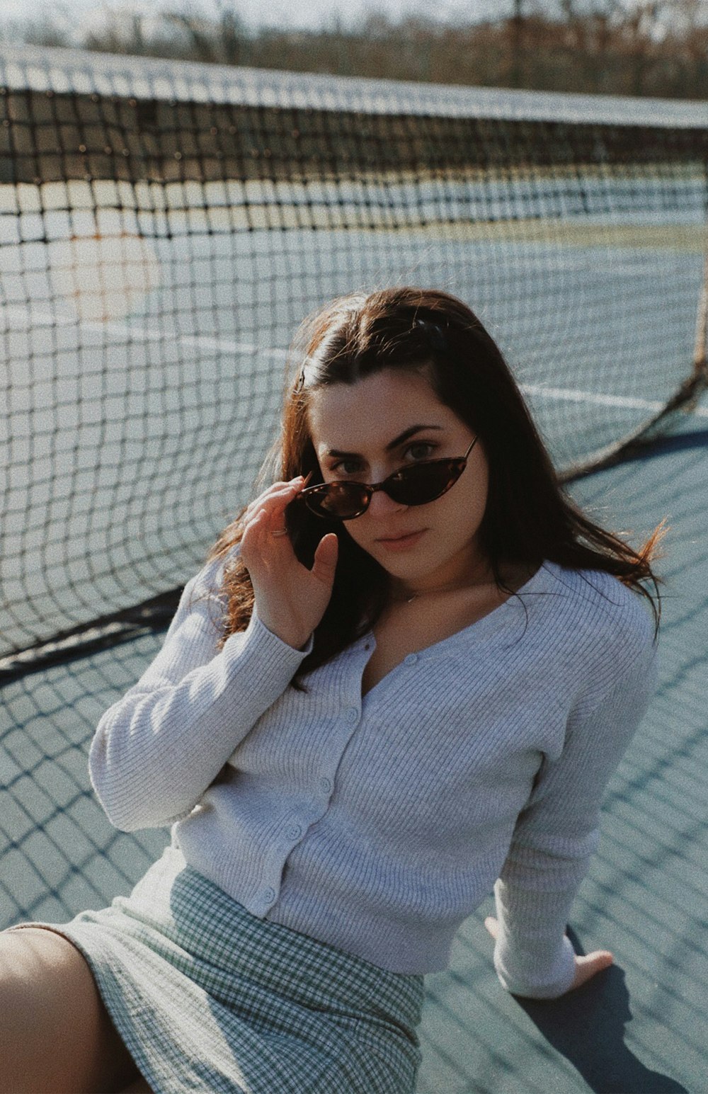 woman in white sweater wearing black sunglasses