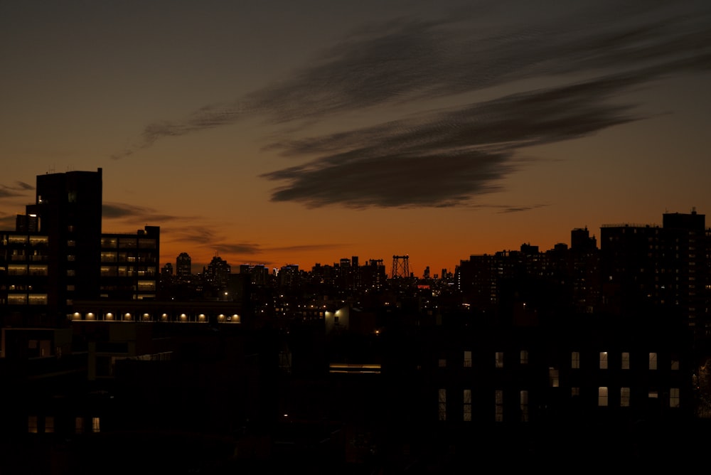 silhouette of city buildings during sunset