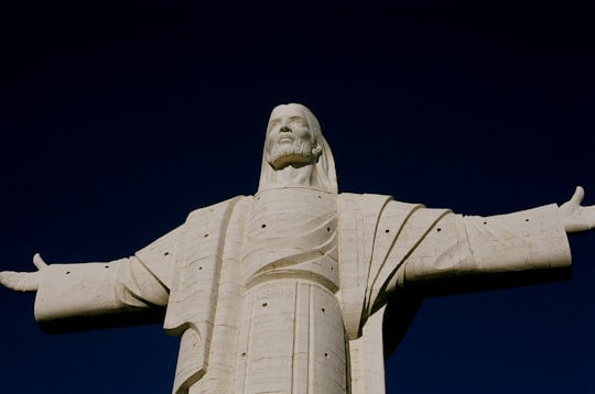 white concrete statue under blue sky during daytime in Cristo de la Concordia Bolivia