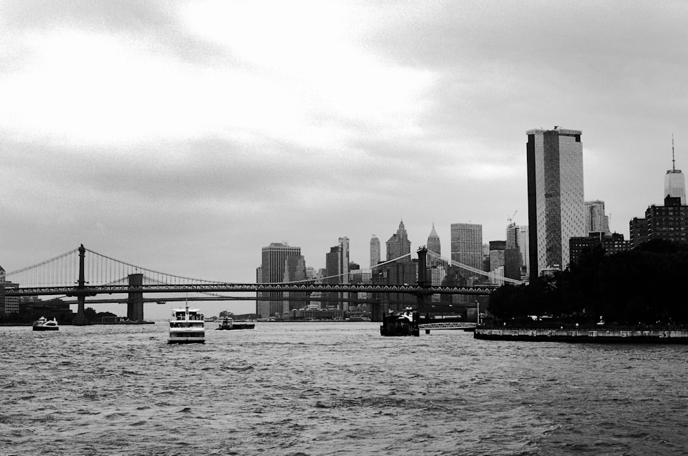 grayscale photo of bridge over body of water