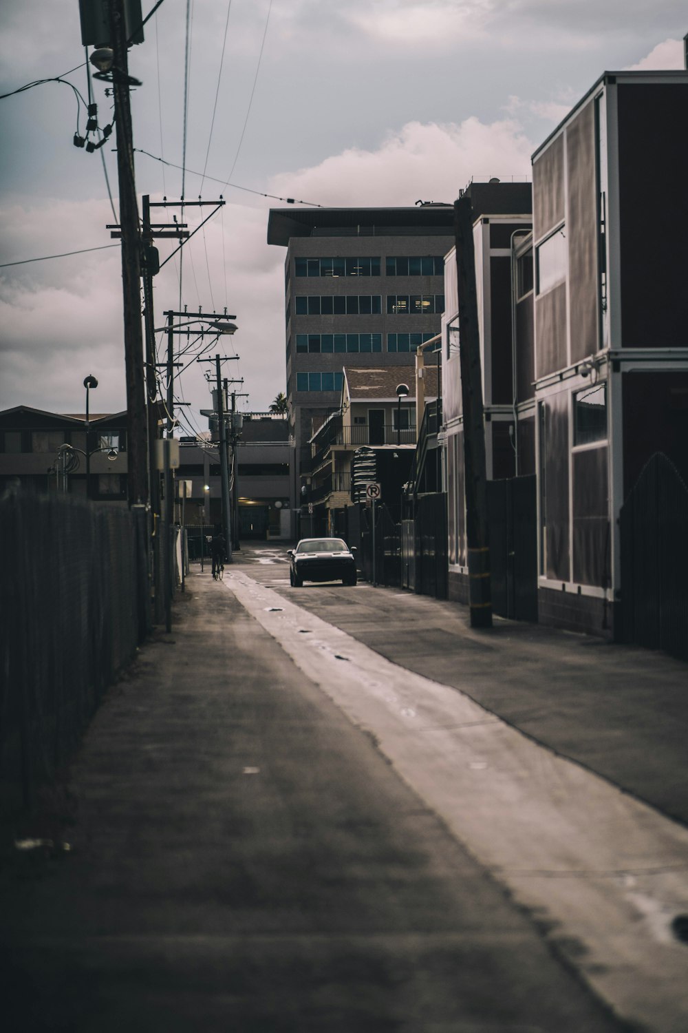 black car parked beside building during daytime