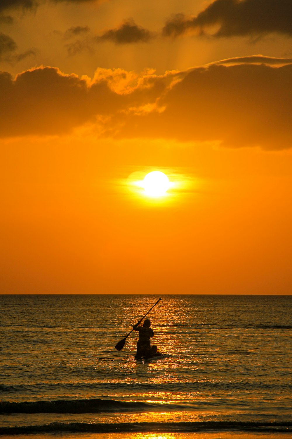 silhouette of man fishing during sunset