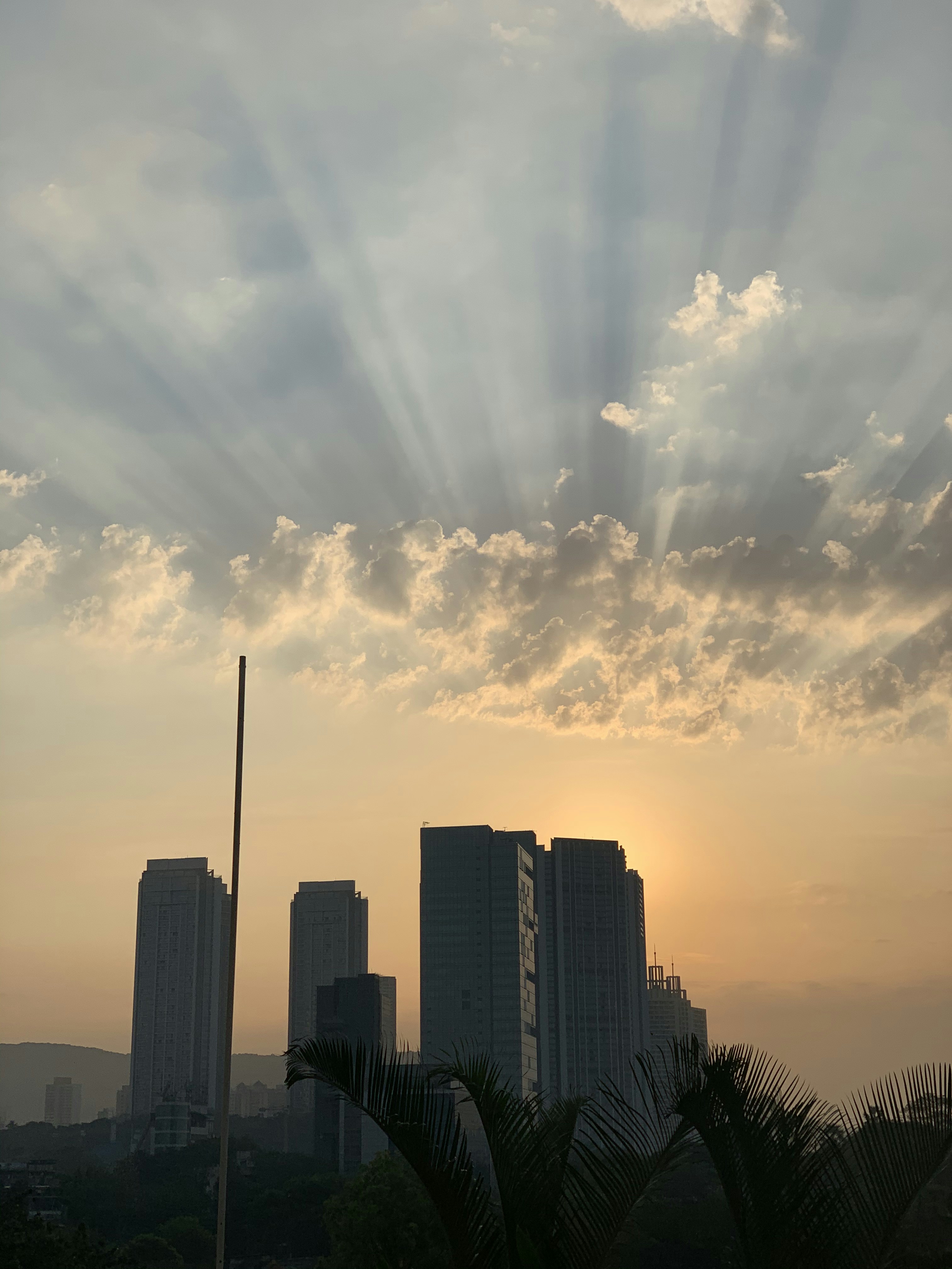 high rise buildings under white clouds and blue sky during daytime