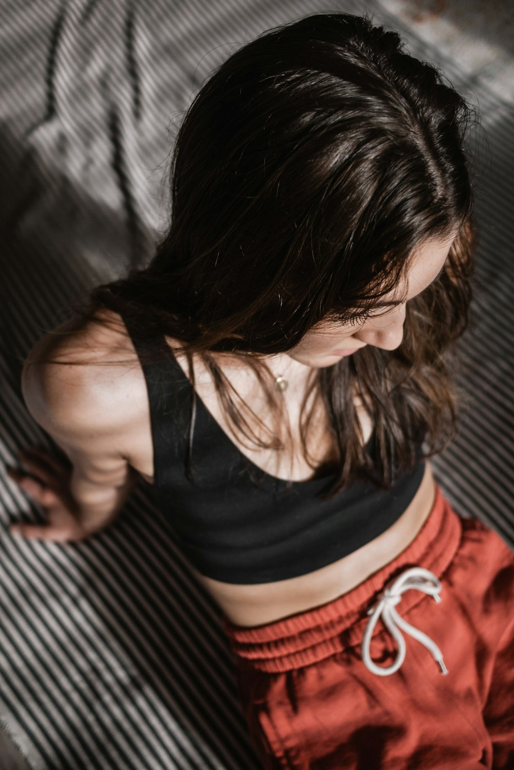 woman in black tank top and red shorts