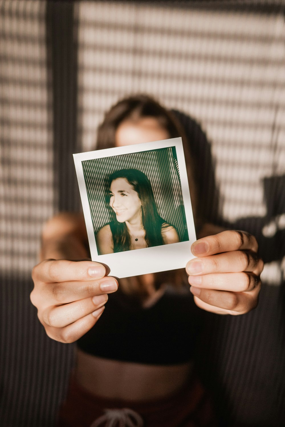 person holding a picture of a woman