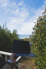 A serene outdoor scene with a tablet showing auravista’s personal brand logo.