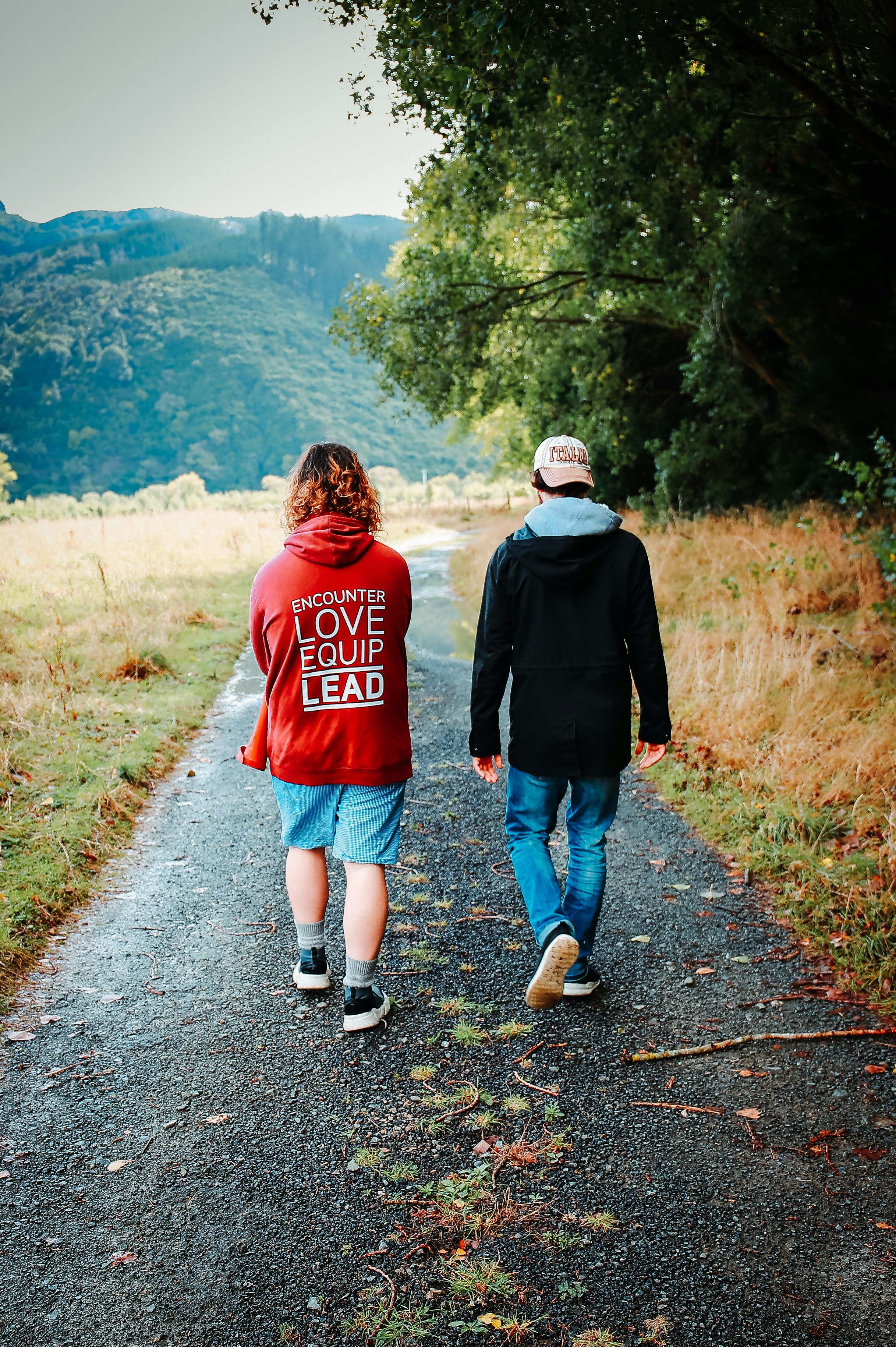 man and woman walking on road during daytime