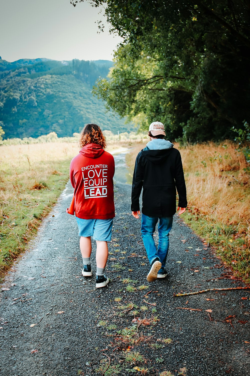 man and woman walking on road during daytime