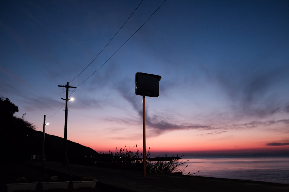 black street sign during sunset