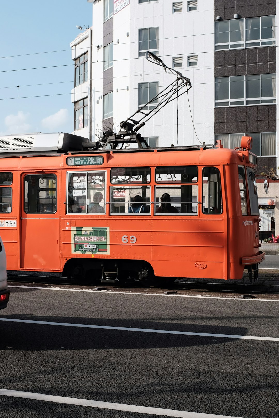 orange and white tram on road during daytime
