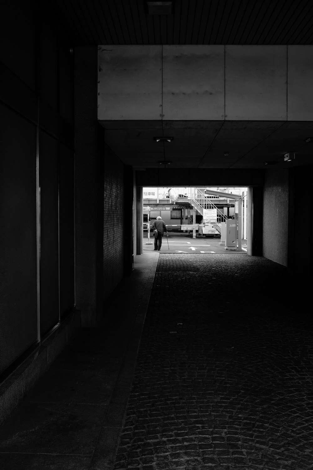 grayscale photo of car parked in garage