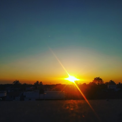 A warm sunset over a horizon symbolizing moving forward into the future.