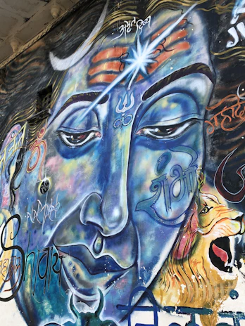 A vibrant mural depicting the moment Shiva burns Manmatha with his third eye.