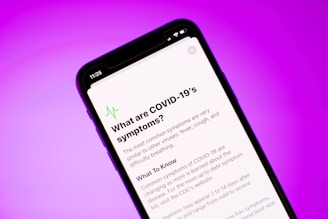 a close up of a cell phone with the text what are covid - 19