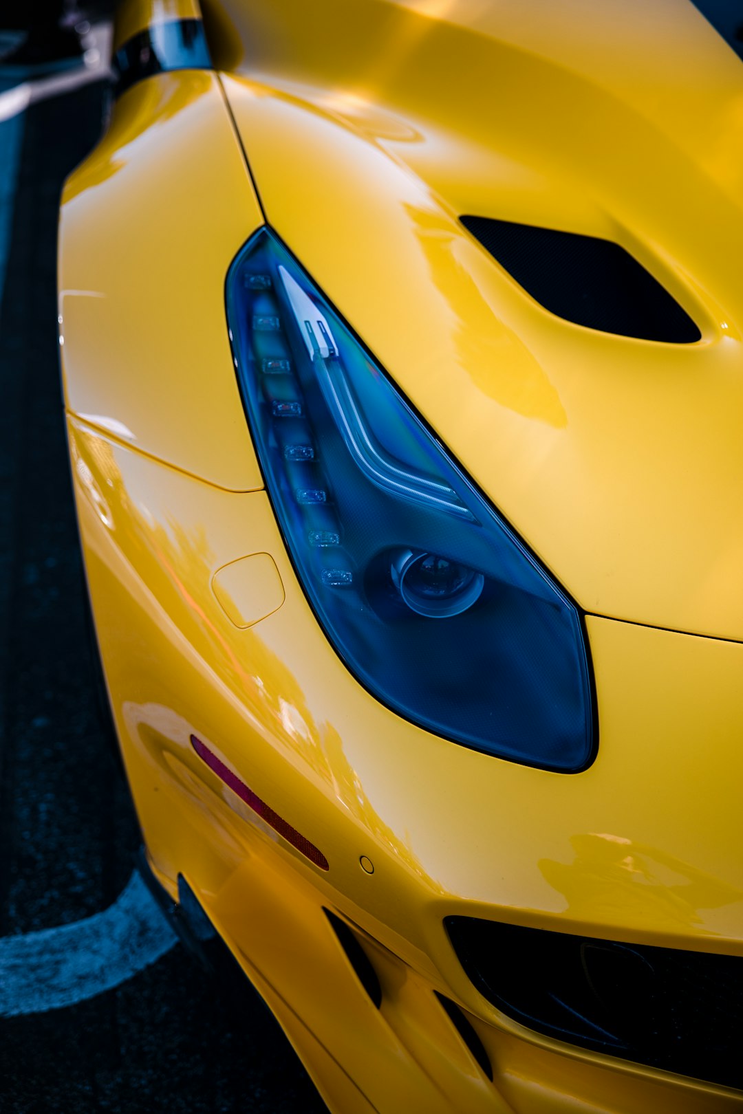 yellow ferrari car with blue and white door lever