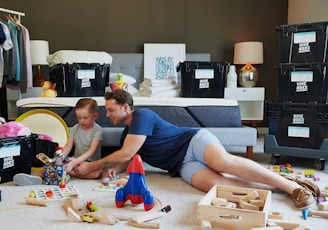 man in blue tank top and gray shorts lying on gray bed