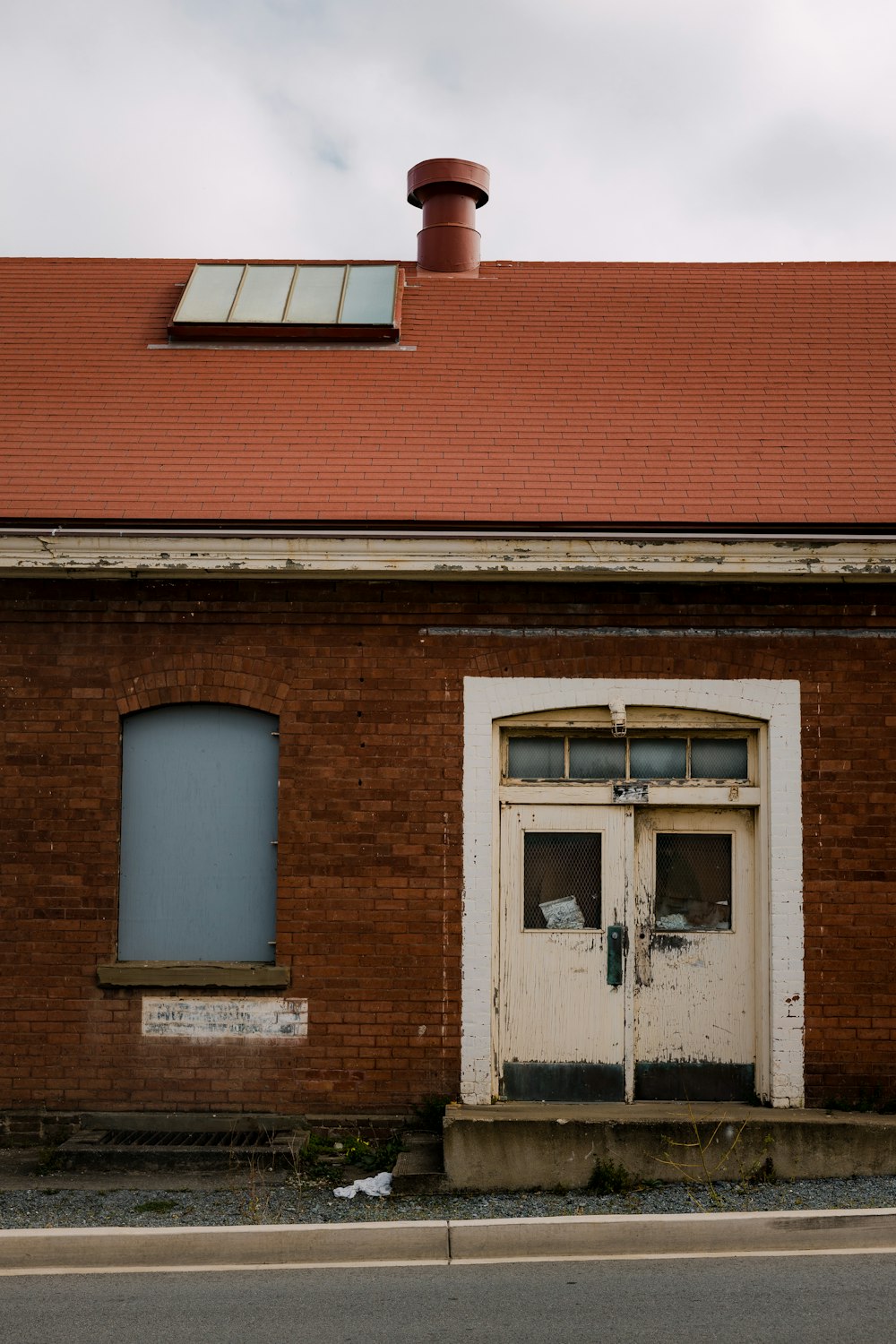 brown brick house with white window