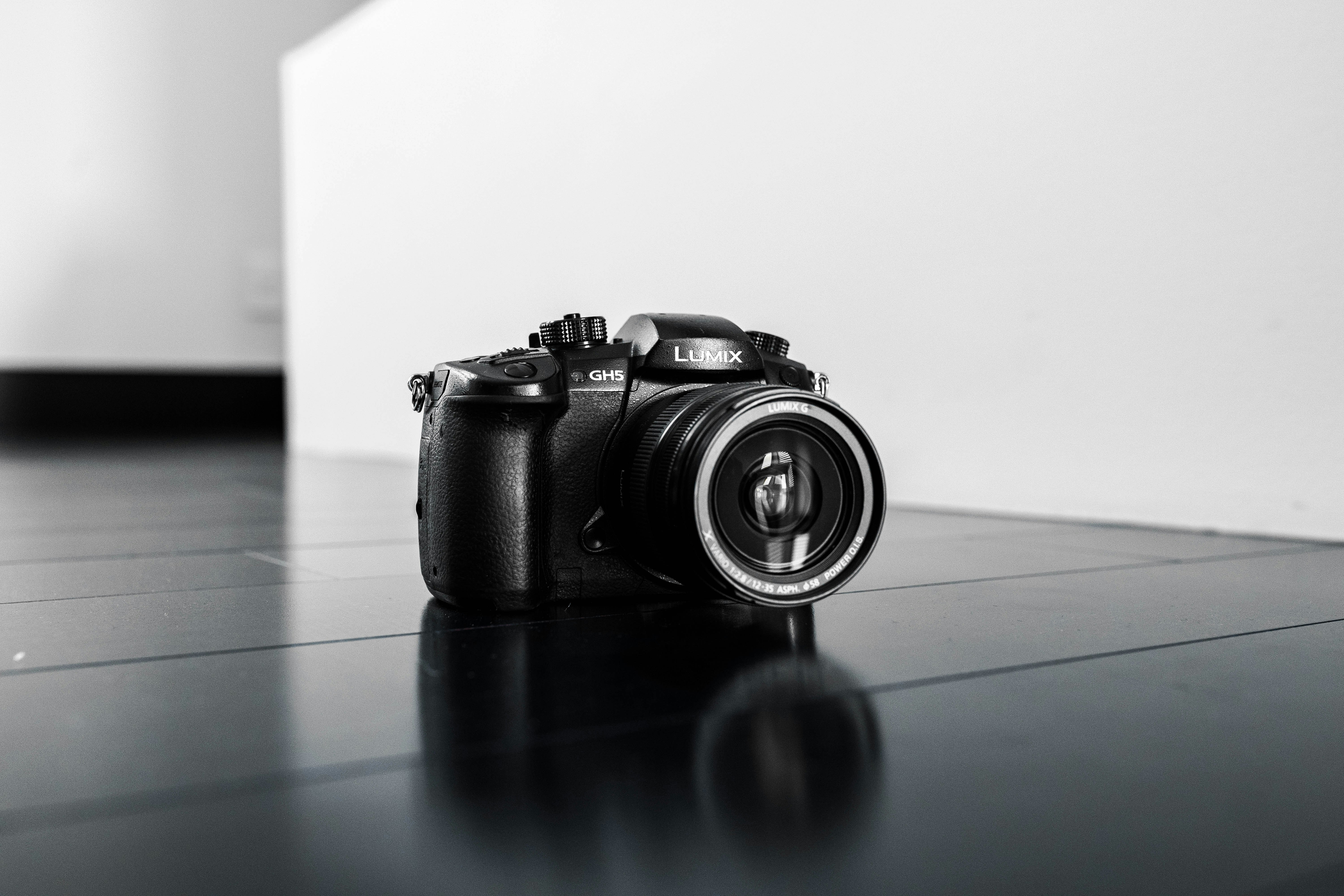 black nikon dslr camera on blue table