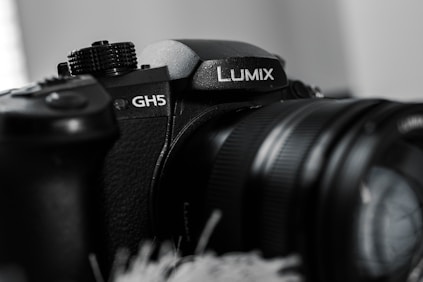 black nikon dslr camera on white textile