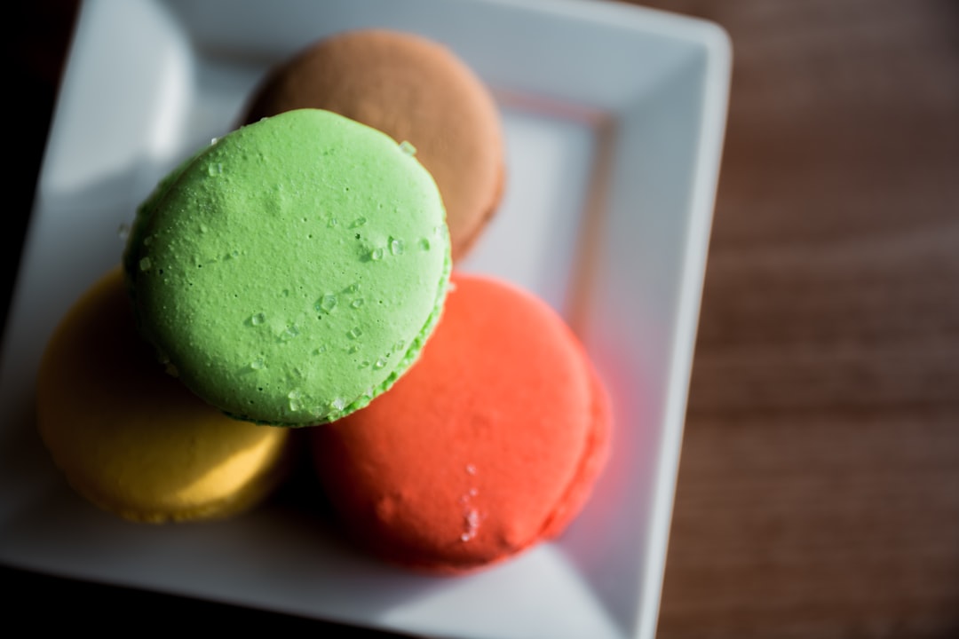 orange and green ice cream on white ceramic bowl