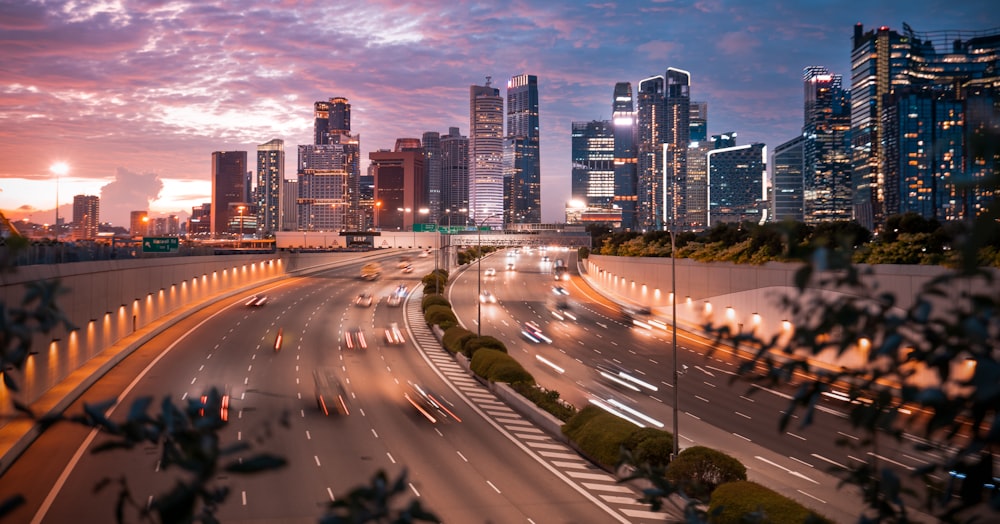 cars on road near city buildings during night time