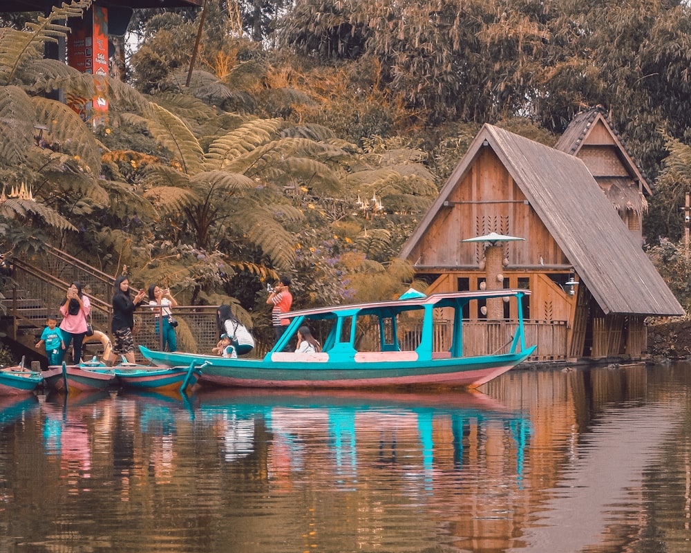 people riding on boat on lake during daytime