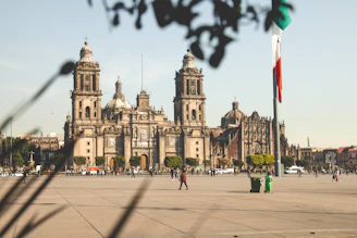 people walking on sidewalk near brown concrete building during daytime