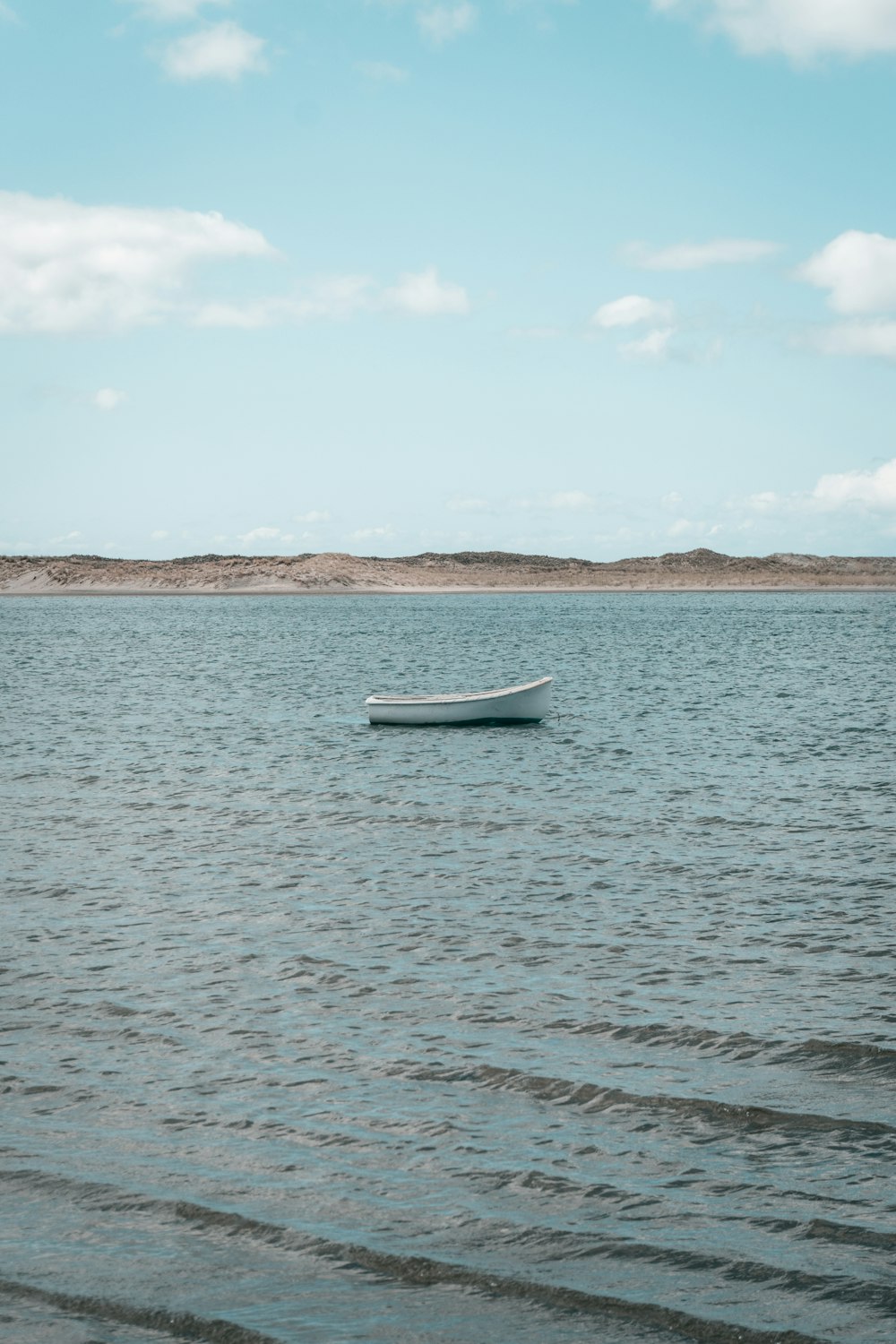 white boat on sea during daytime