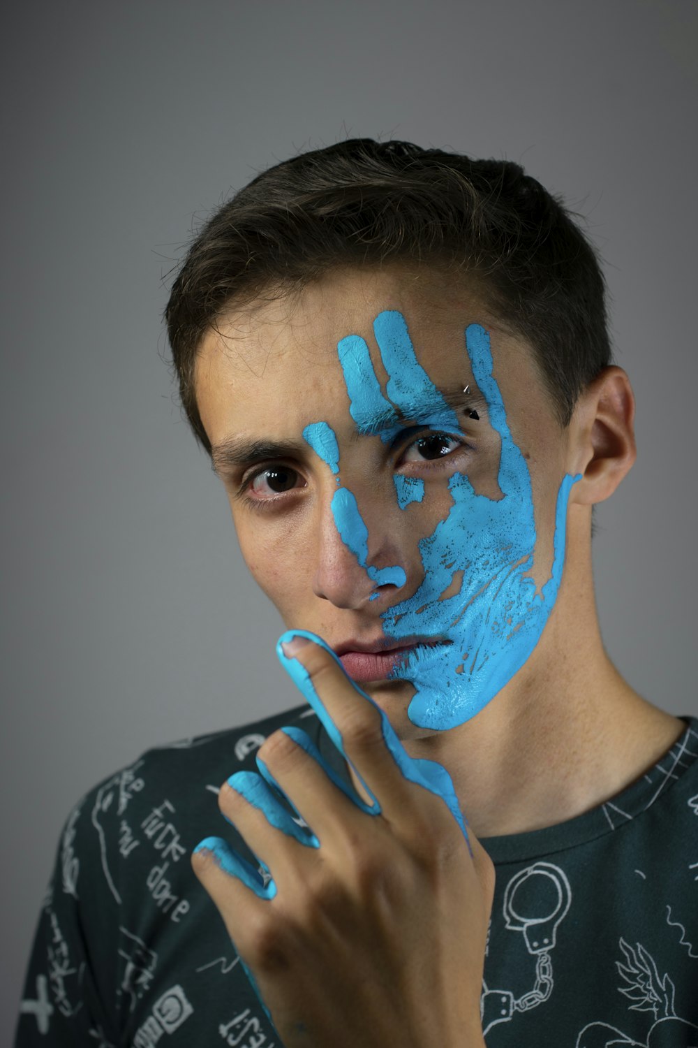 woman in black and white crew neck shirt with blue face paint