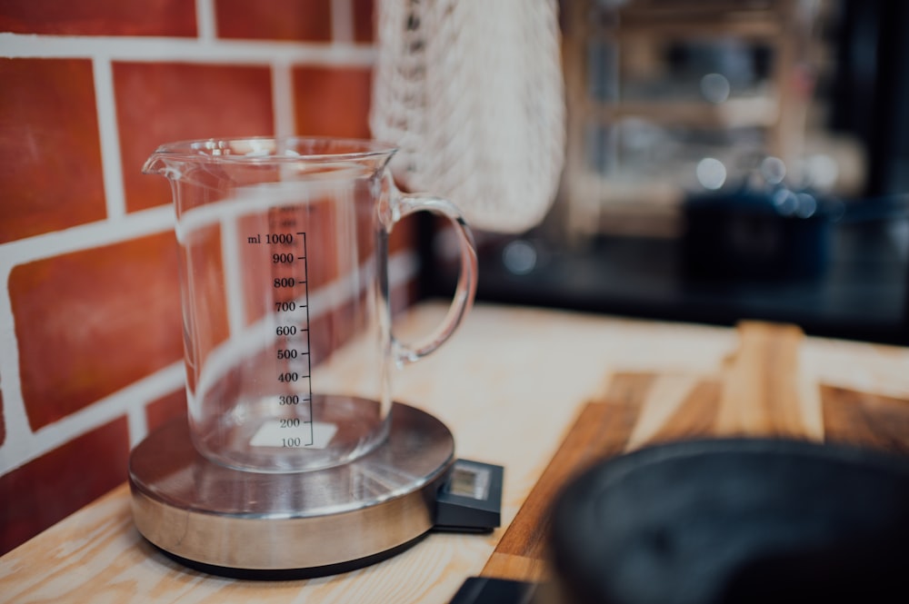 clear glass mug on brown wooden table