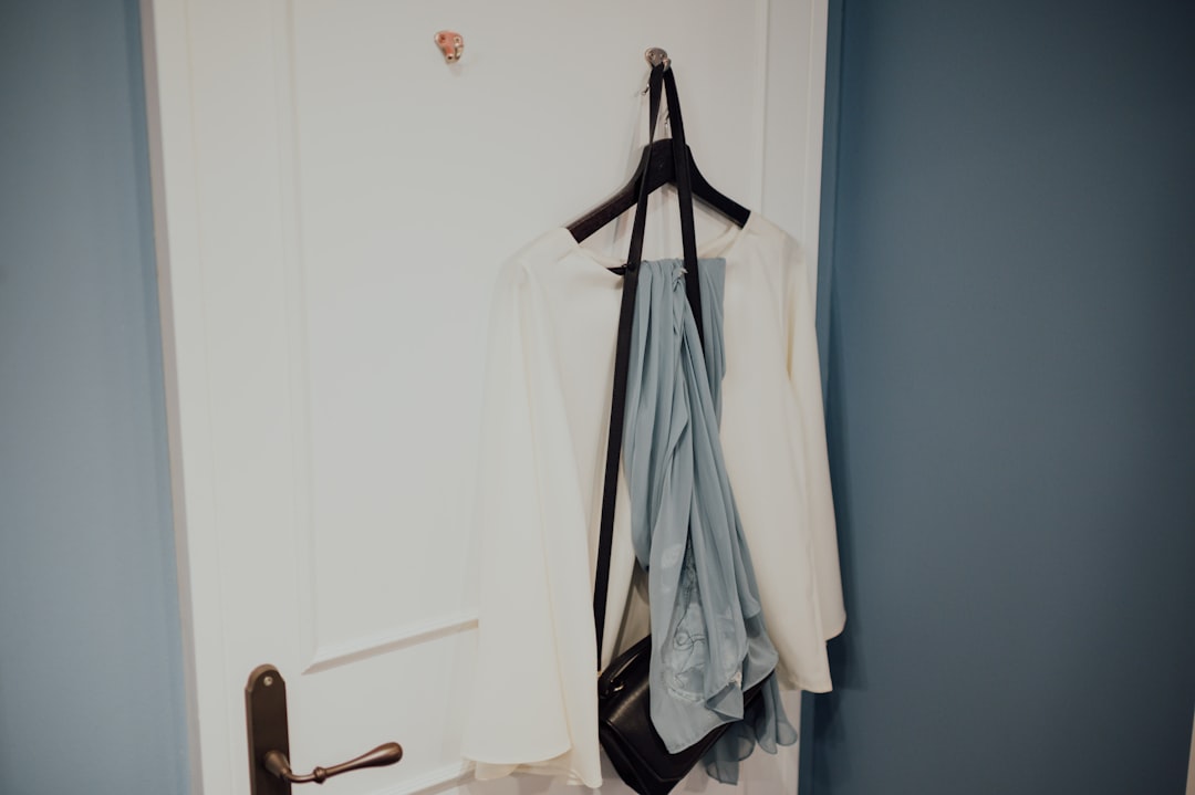 white coat hanged on black clothes hanger