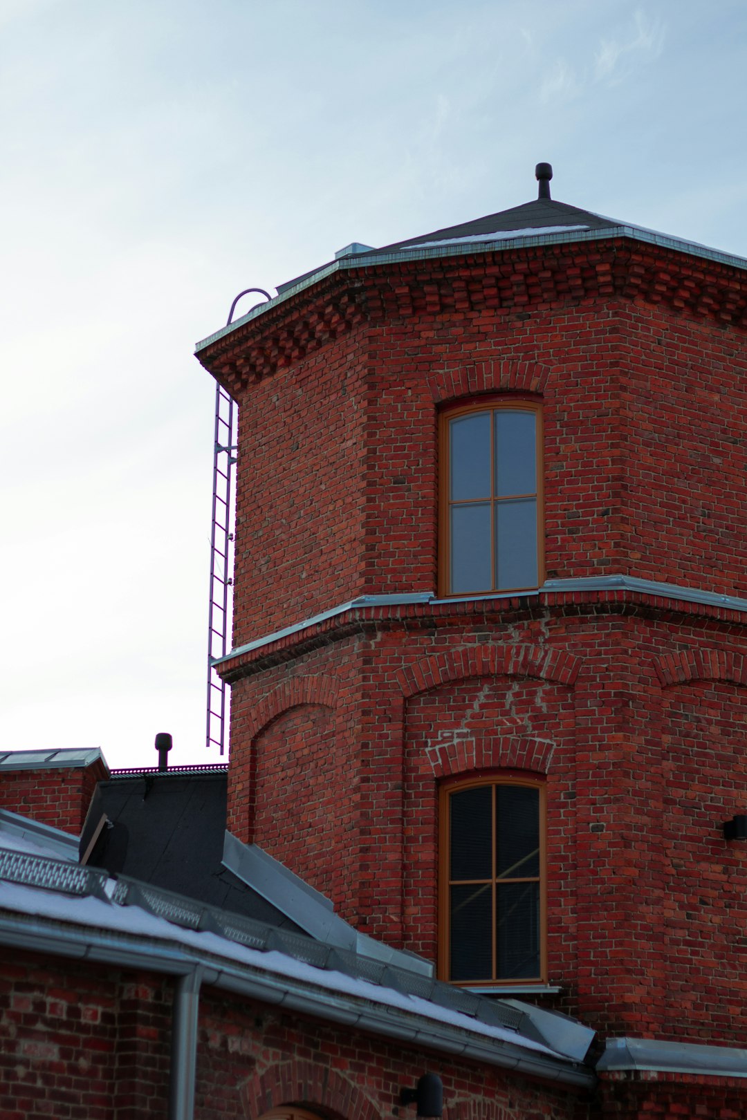 brown brick building under white sky during daytime