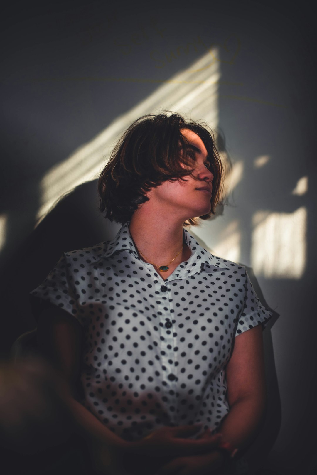 woman in white and black polka dot button up shirt